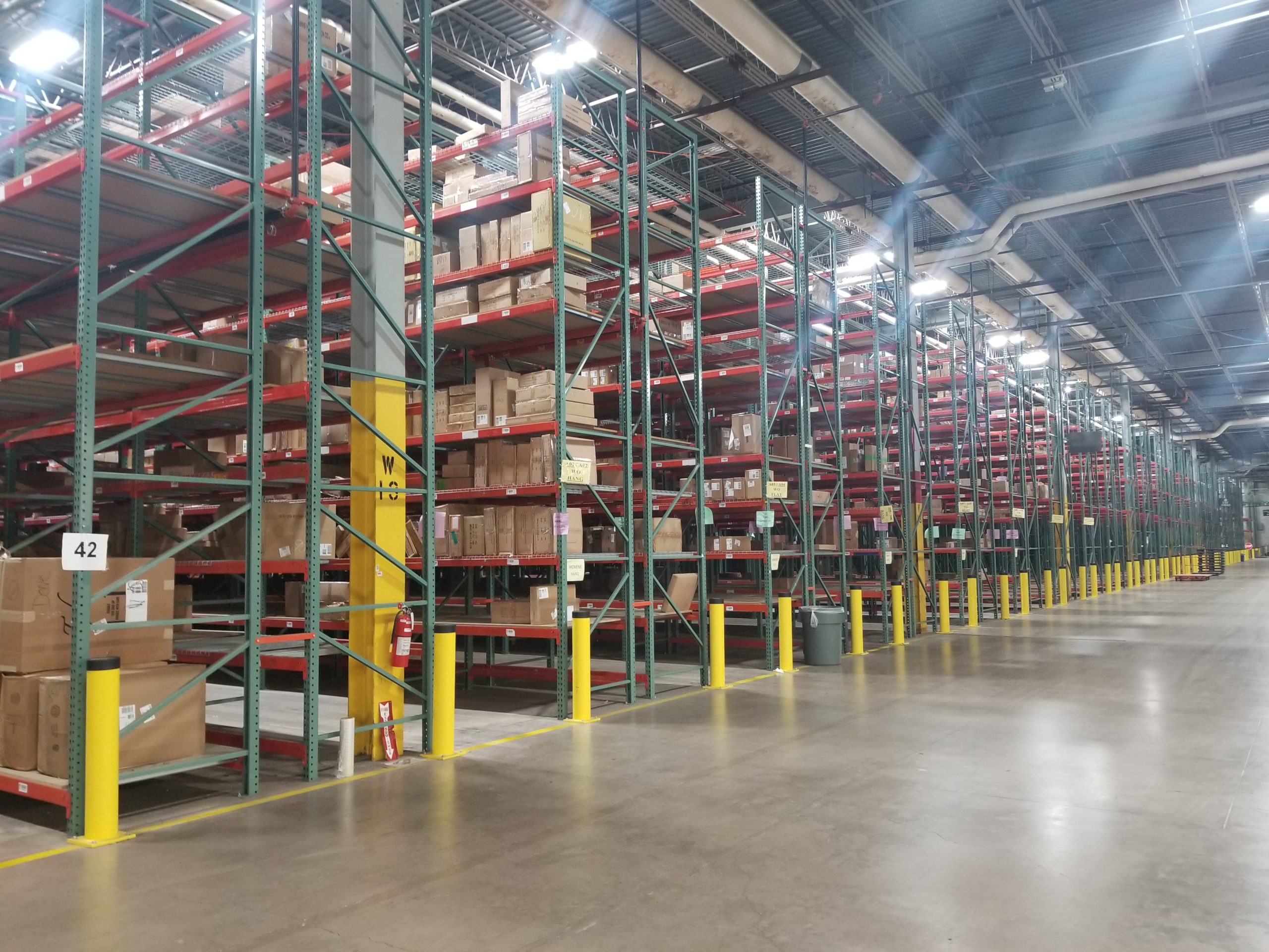 Used pallet racking systems with boxes in warehouse