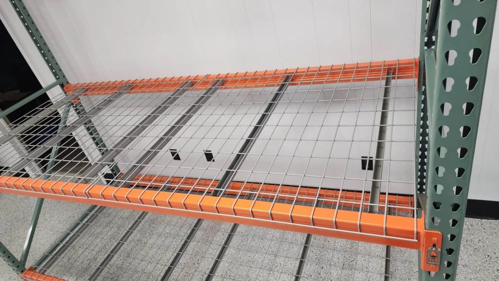 Pallet rack shelf with used wire decking for support