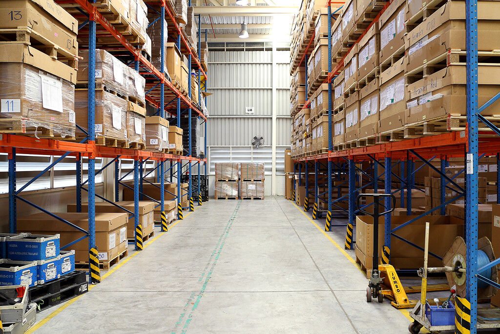 Industrial warehouse aisle with stacked used racks