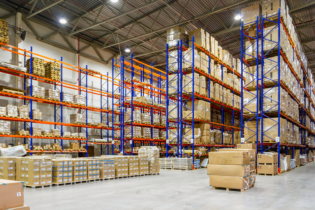 Large warehouse with used pallet racks for inventory storage